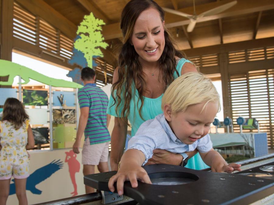 Mother and son exploring the Interpretive Center at Gulf State Park