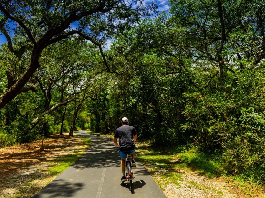 Man biking on trails in Gulf Shores, AL