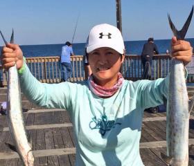 Woman with Spanish mackerel catches on Alabama's beaches