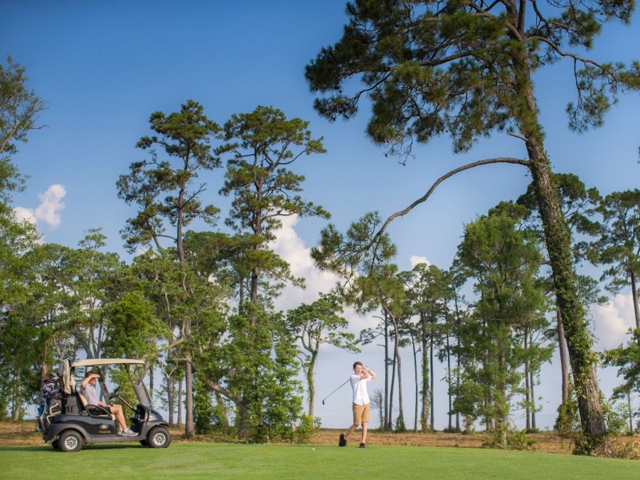 Golfers playing at Peninsula Golf & Racquet Club in Fort Morgan