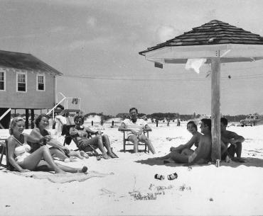 Vintage photo of people enjoying the beach in Gulf Shores in the 1950s.