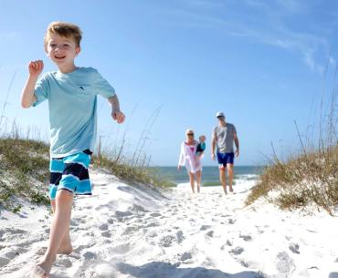 Family running on beach