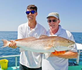 Anglers with a redfish caught in Orange Beach