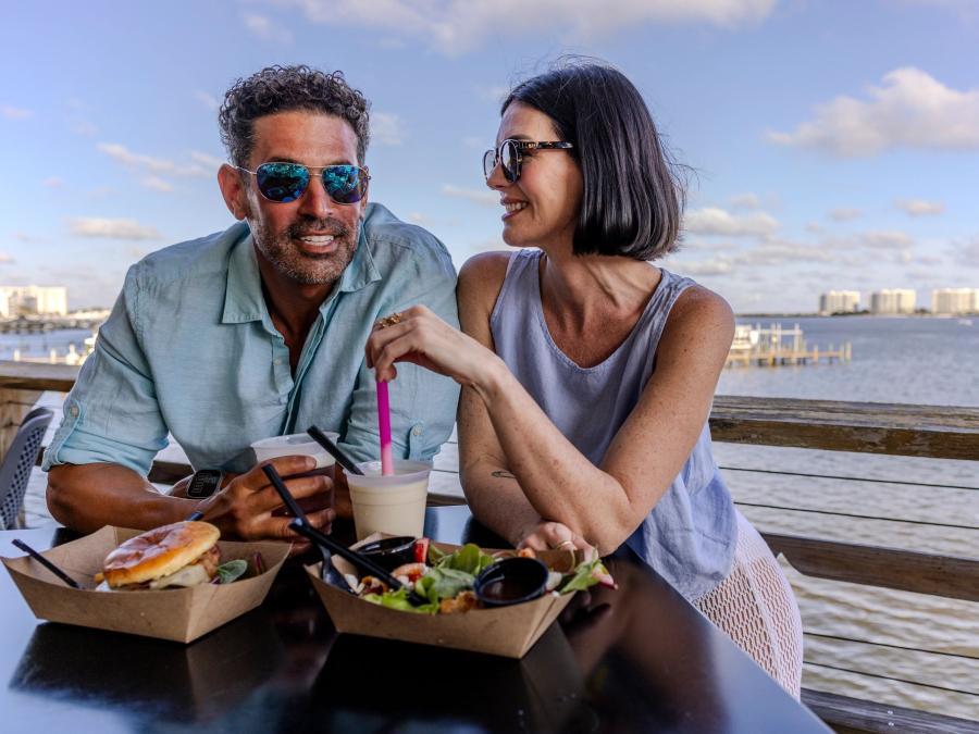 Couple dining at Avenue Pub waterfront restaurant in Orange Beach