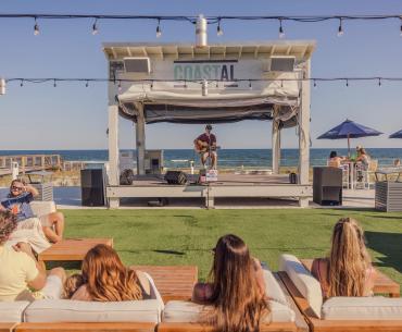 People listening to live music at Coastal beachfront restaurant in Orange Beach
