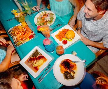 Aerial shot of people gathered around a table filled with food at GTs on the Bay