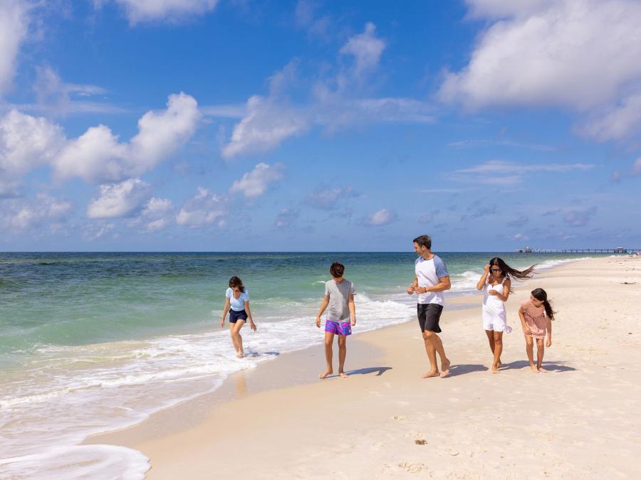 Family walking together along the shore in Orange Beach