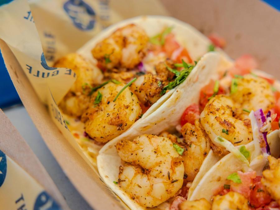 A close-up shot of fresh shrimp tacos at The Gulf beachfront restaurant in Orange Beach
