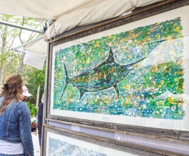 A visitor enjoying art at the OB Festival of Art