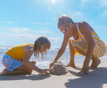 grandma and grandkid playing on the beach in gulf shores