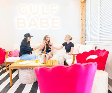 Friends enjoying drinks at Gulf Babe Wine Co. at The Wharf in Orange Beach