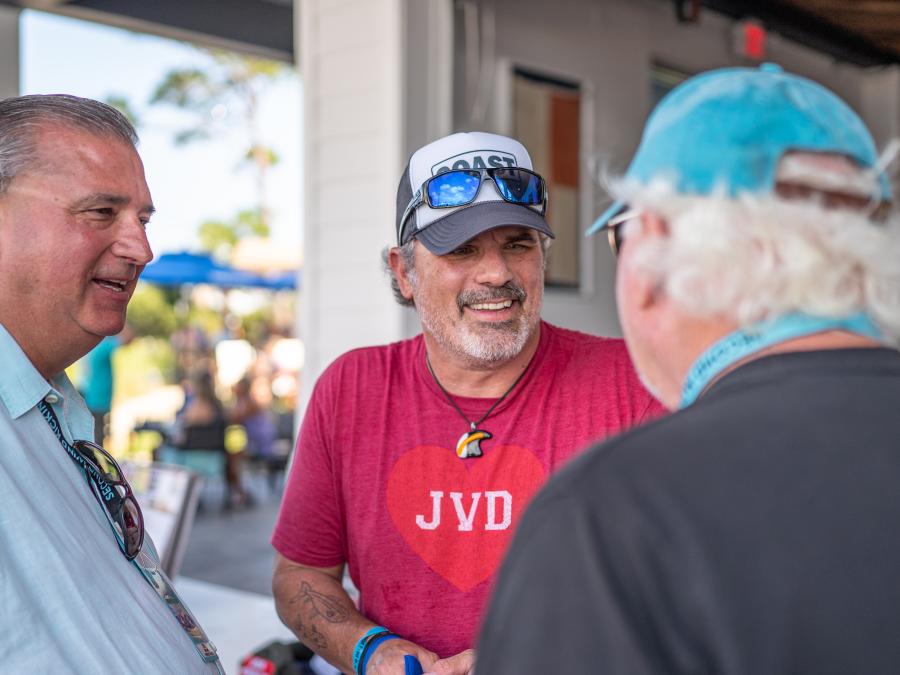 Men laughing and bonding at Snowbird club on Alabama's Beaches