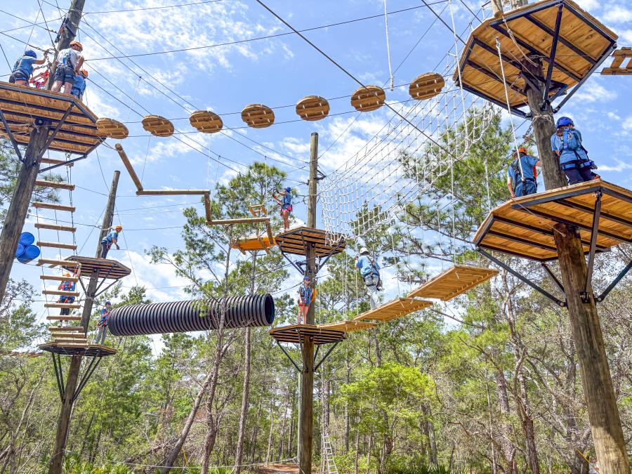 Visitors taking on the ropes course at the eco-center