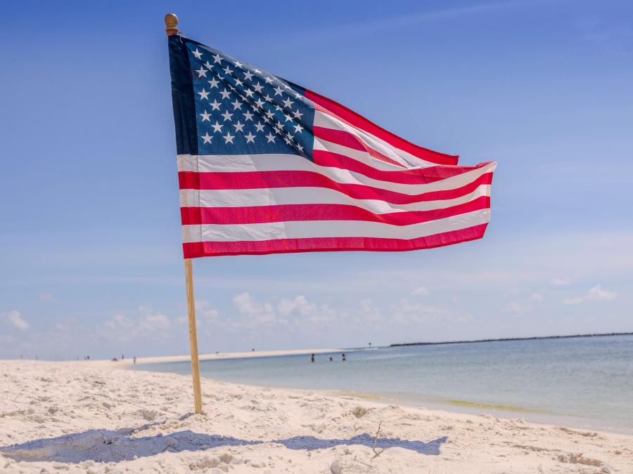 American flag on the beach waving in the wind