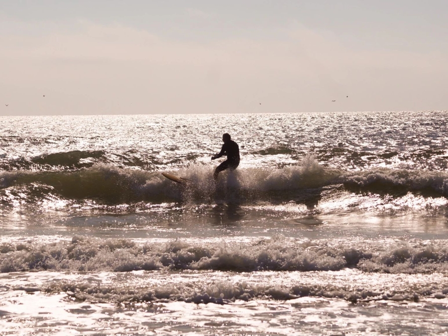 Man surfing at Cotton Bayou in Orange Beach