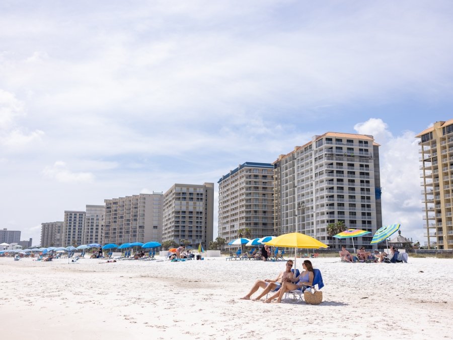 couple relaxing in beach chairs by the shore in Orange Beach
