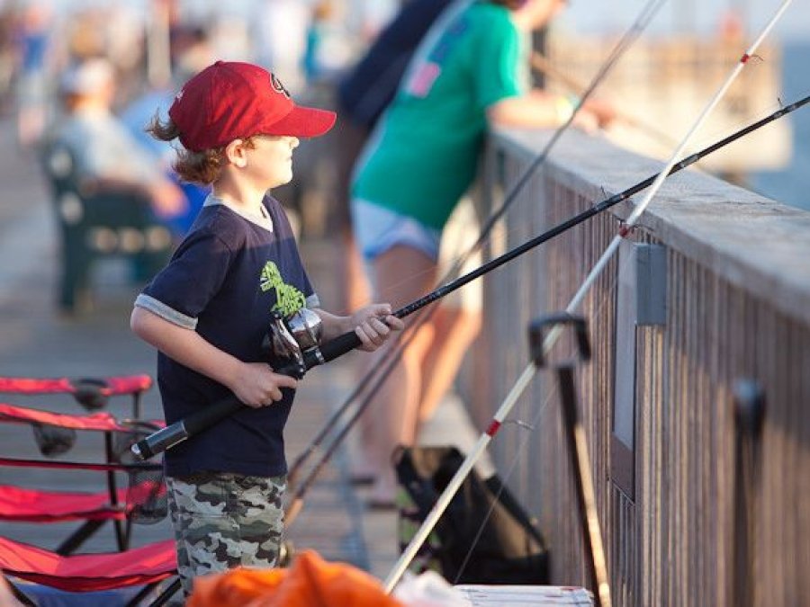 Kid fishing off the Gulf State Park Pier in Gulf Shores