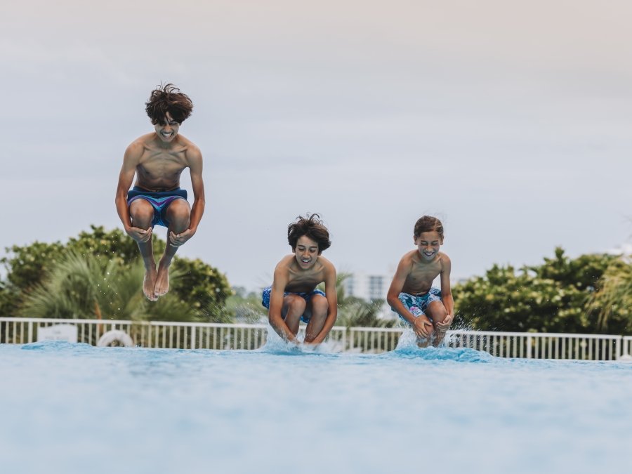 Kids jumping into the pool at the Caribe.