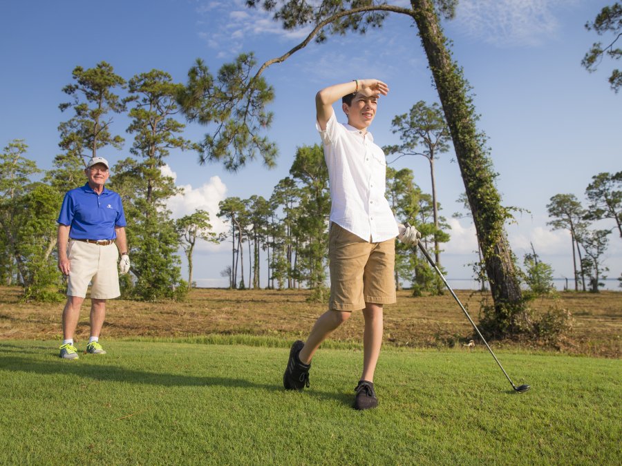Dad and son golfing at Peninsula golf course in Gulf Shores