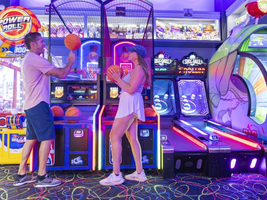 A couple playing game at The Track arcade.