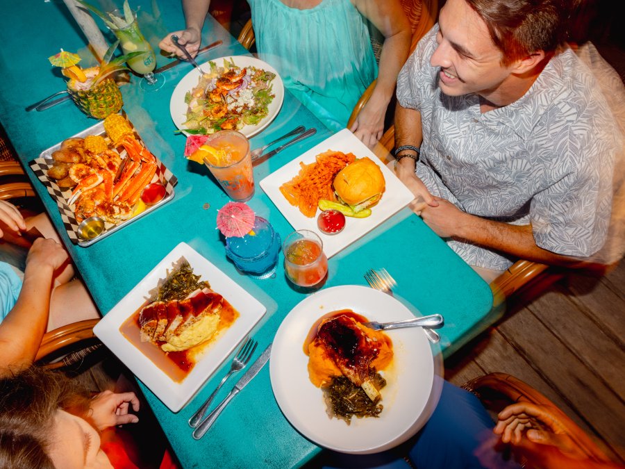 Friends dining on the outdoor patio at GTs on the Bay waterfront restaurant in Orange Beach