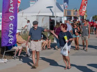 Couple strolling the beachfront grounds of the Annual National Shrimp Festival in Gulf Shores