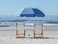 two beach chairs and an umbrella sitting in the sand near the water in Orange Beach