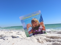 Vacation Guide sitting on the sand on Alabama's Beaches