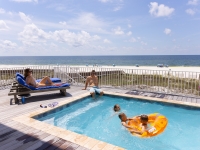 A family enjoying their Orange Beach rental at the pool.