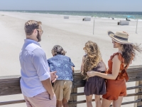 A family on The Lodge Pier with a beach view
