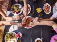 Hands grabbing royal red shrimp at Sea-N-Suds seafood restaurant in Gulf Shores