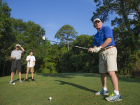 Family golfing together on Alabama's Beaches