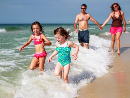 family splashing in the ocean