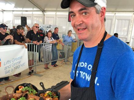 Man holding tray of food at World Food Championships in Orange Beach AL