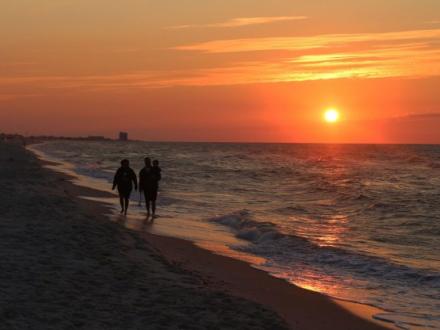Couple walking at sunset Orange Beach
