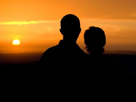 couple watching the sun set in Orange Beach AL