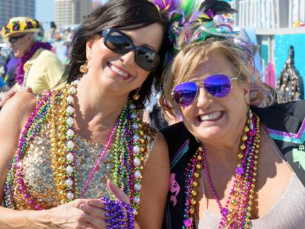 Woman celebrate Mardi Gras on Alabama's Beaches