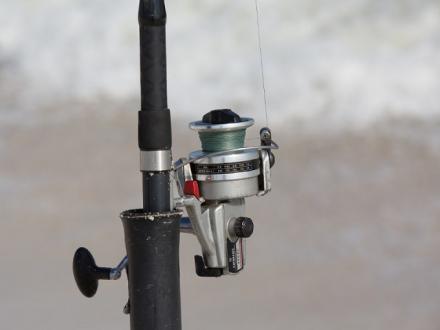 rod and reel on the beach in Gulf Shores AL