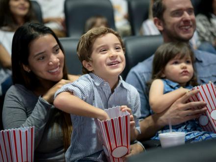 Family watching movie at theater