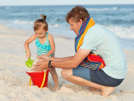 Father and Daughter play in Sand on Alabama's Beaches