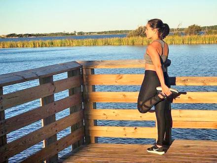 Runner stretching on Hugh S. Branyon BackCountry Trail in Orange Beach