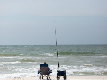 Man fishing on the beach in Orange Beach AL
