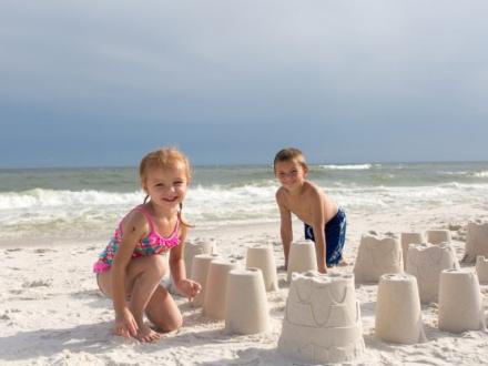 two young kids building a sandcastle