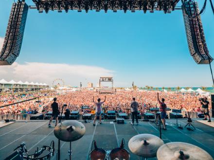 four band members on stage looking at the Hangout crowd