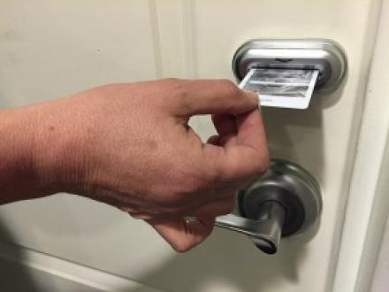 person inserting room key