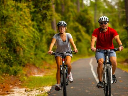 Couple riding bikes in the woods