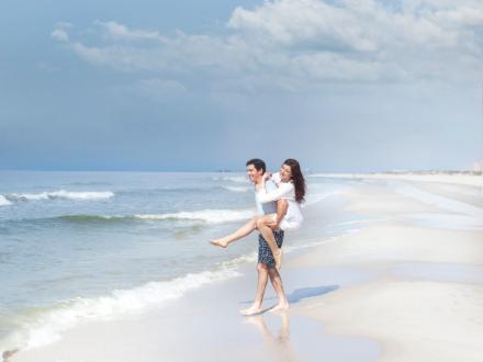 couple playing in the surf in Gulf Shores and Orange Beach Al