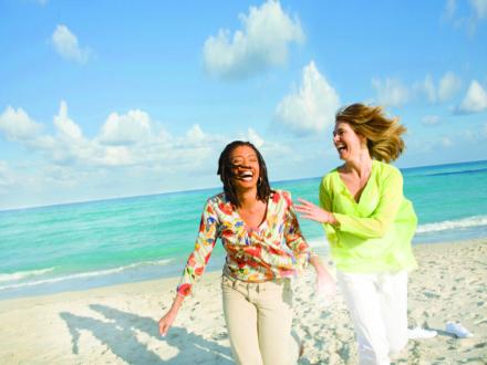 two women walking on the beach in Orange Beach Al