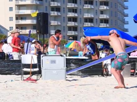 Man throwing fish at Interstate Mullet Toss at Flora-Bama