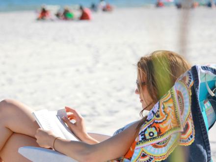 Woman reading on Alabama's white sand beaches